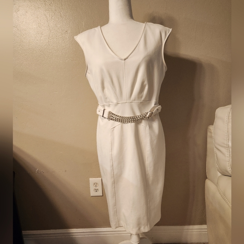 Off white strech j-lo dress. Built in shoulder pads. Silver chains across front.